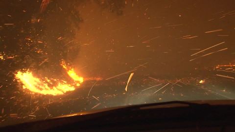 A driver tries to get past the Kincade Fire in Northern California.