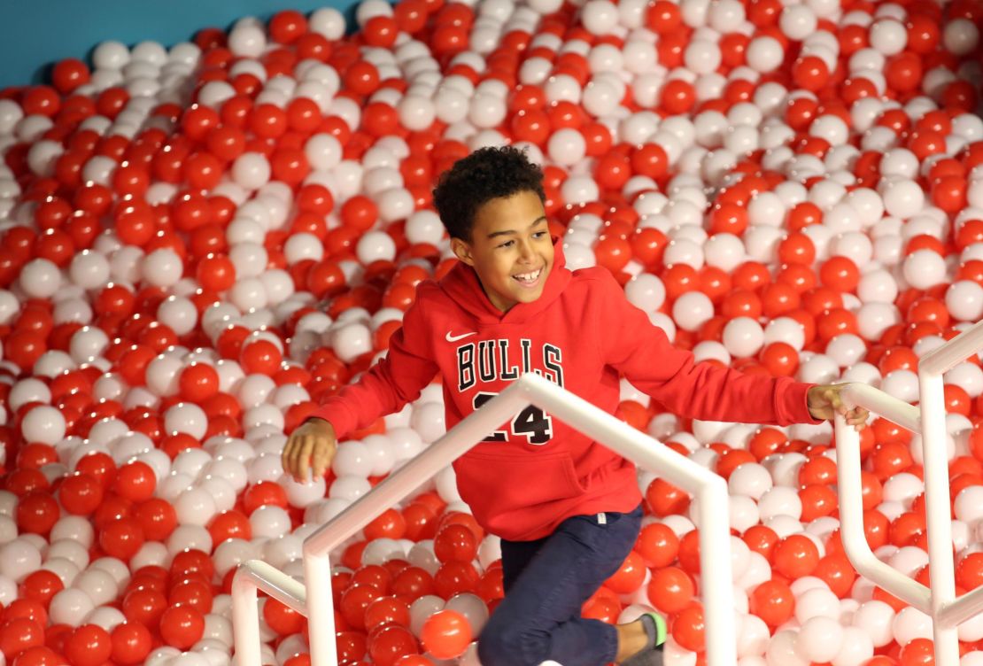 A child plays in a ball pit at Toys "R" Us Adventure Chicago Opening Preview on October 23, 2019 in Chicago