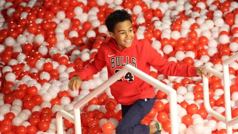A child plays in a ball pit at Toys "R" Us Adventure Chicago Opening Preview on October 23, 2019 in Chicago