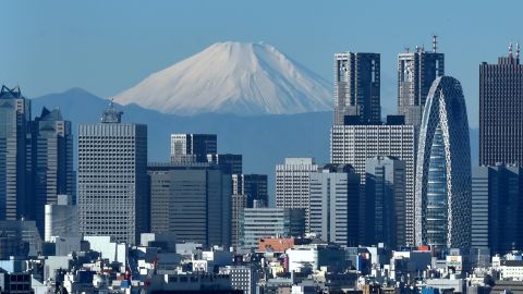 A snow-covered Mount Fuji is seen behind Tokyo in this file photo from 2014. 