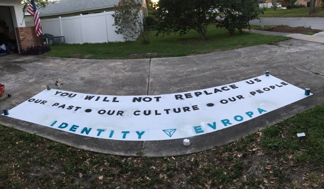 An Identity Evropa banner made on a driveway.