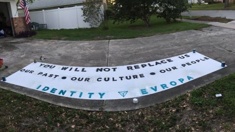 An Identity Evropa banner made on a driveway.