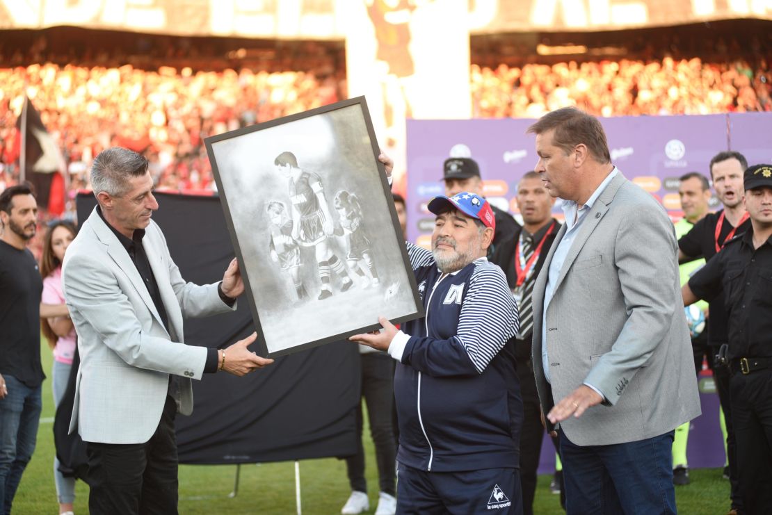 Diego Maradona was presented with painting of himself playing for Newell's.
