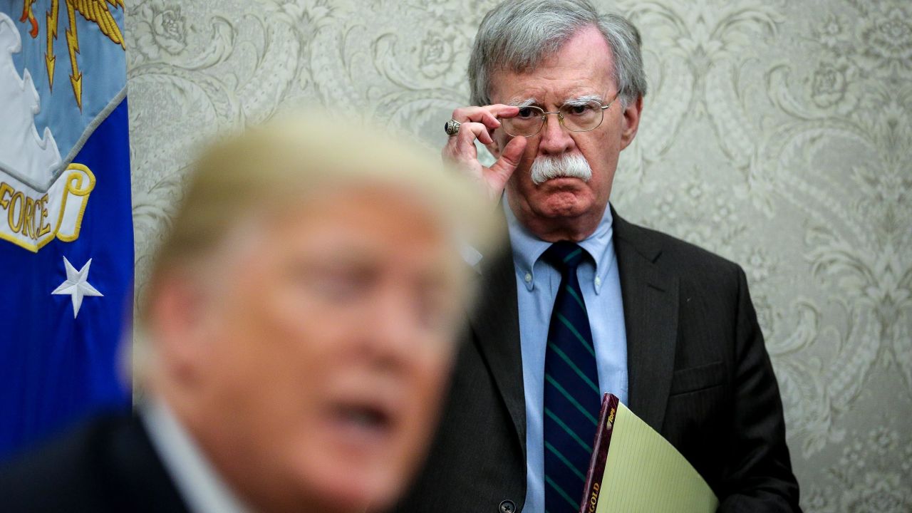 National security advisor, John Bolton, right, attends a meeting with President Donald Trump and President of Chile, Sebastian Pi?era in the Oval Office of the White House on September 28, 2018 in Washington, DC.