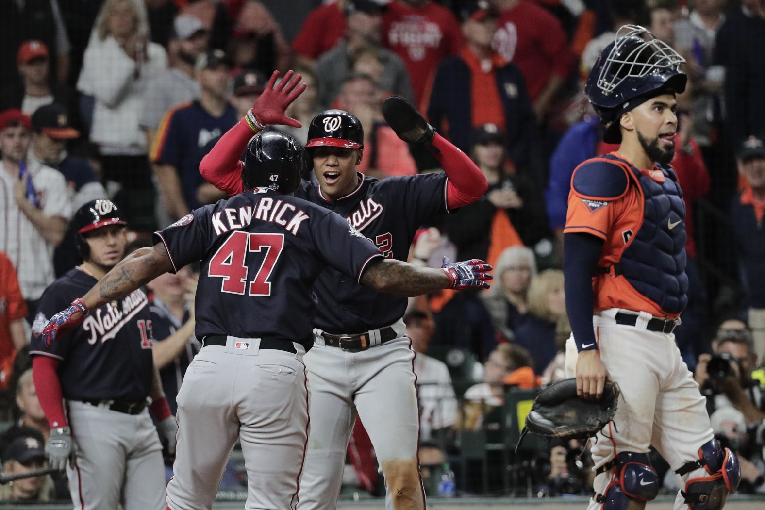 Washington's Howie Kendrick is congratulated by teammate Juan Soto after his home run gave the Nationals a 3-2 lead in the seventh inning.