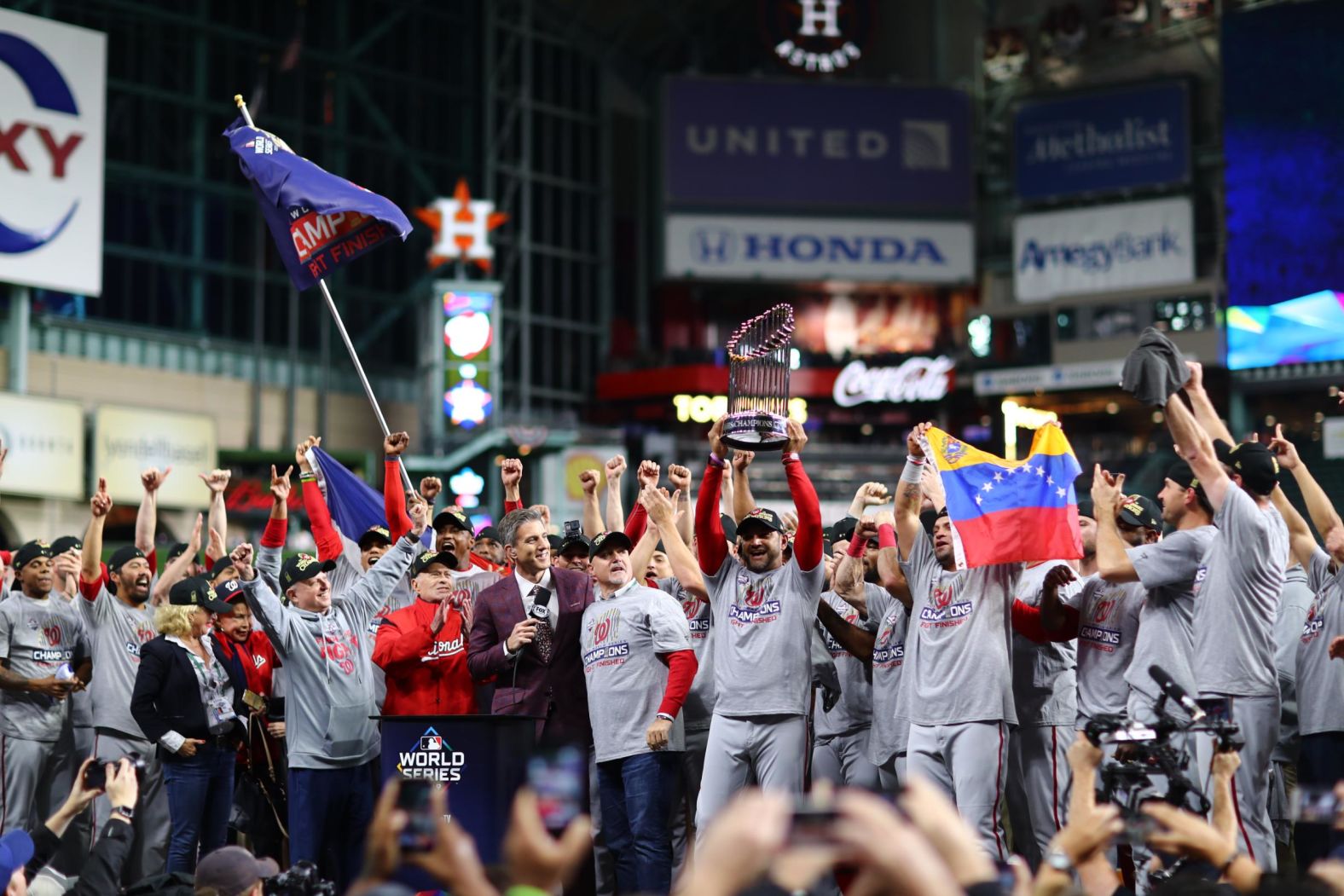 Nationals manager Dave Martinez raises the trophy.