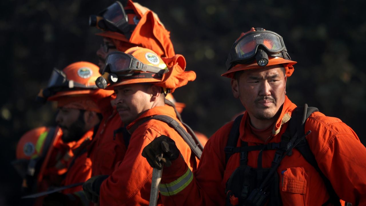 Inmate firefighters take a break while battling the Kincade Fire this week in Healdsburg, California.