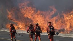 Inmate firefighters prepare to put out flame on the road leading to the Reagan Presidential Library during the Easy Fire in Simi Valley, California on October 30, 2019. (Photo by Mark RALSTON / AFP) (Photo by MARK RALSTON/AFP via Getty Images)