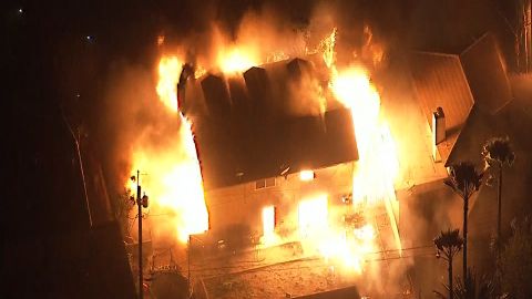 A fire consumes a home Thursday in northern San Bernardino.