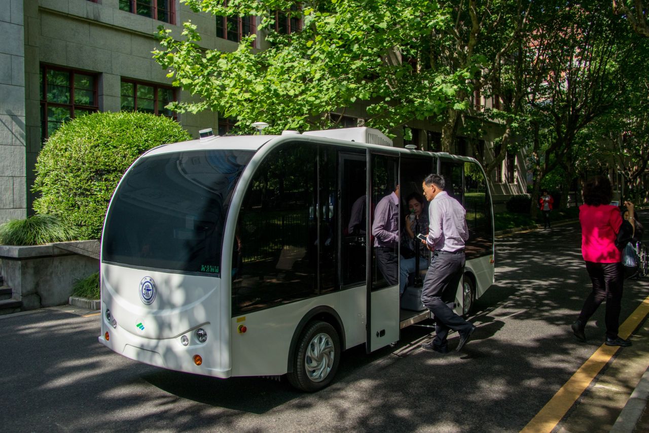 Passengers board a self-driving minibus at Shanghai Jiao Tong University in Shanghai, China.