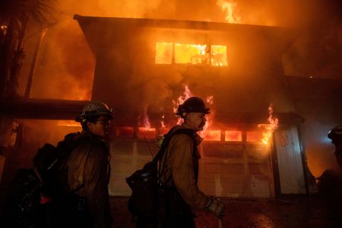 Firefighters work to prevent a blaze from spreading to other homes in San Bernardino.