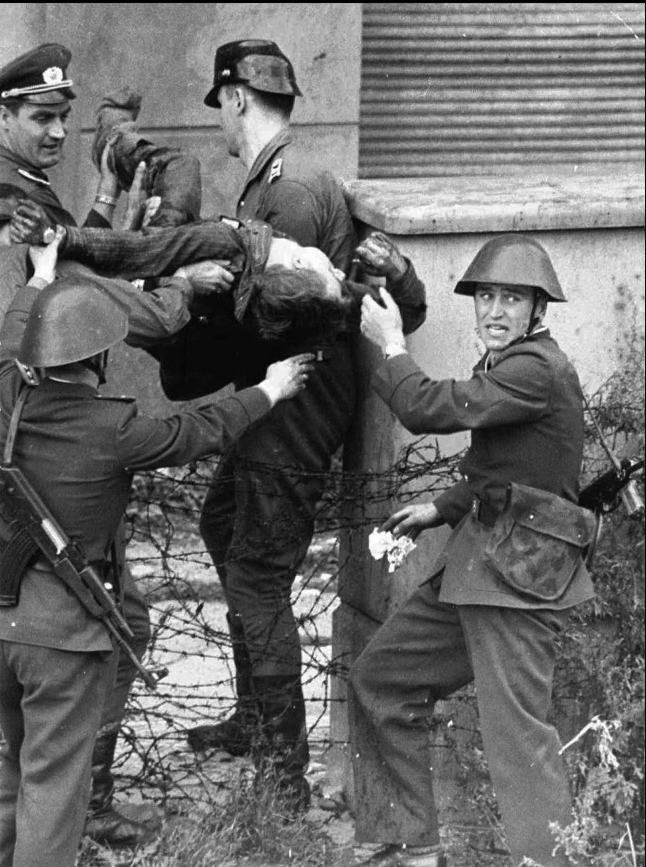 East German bricklayer Peter Fechter, 18, is carried away by border guards after being shot and fatally wounded while attempting to flee to the West in August, 1962. <a href="https://www.britannica.com/topic/Berlin-Wall" target="_blank" target="_blank">Almost 200 </a>people were killed attempting to cross the Wall between 1961 and 1989.