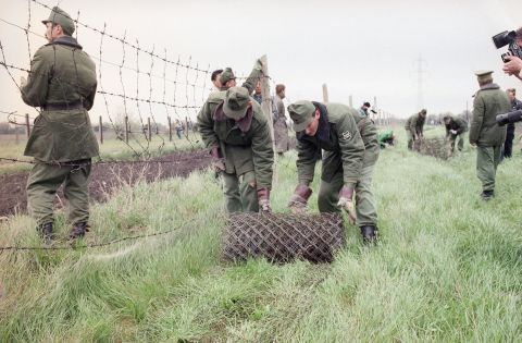 Hungarian border guards begin dismantling the "Iron Curtain" in May 1989, opening the country's border with Austria.