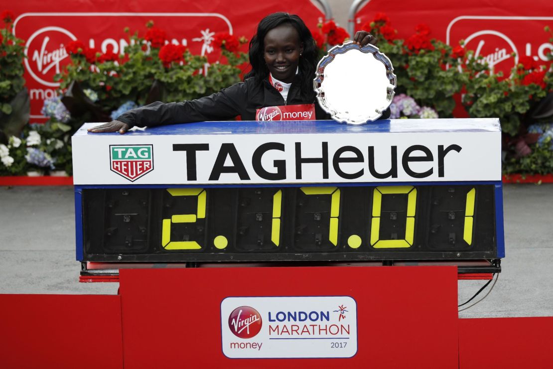 Mary Keitany poses by her official time after winning the women's elite race at the 2017 London marathon.