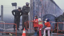 File Photo: West German School Children On The Way To School Come Across The Berlin Wall Being Opened With Two East German Border Guards During The Collapse Of Communism In East Berlin On November 14, 1989. November, 1999 Marks The 10Th Anniversary Of The Fall Of The Berlin Wall. East Germany's Communist Government Erected The Berlin Wall In August 1961. The Wall Fell After Weeks Of Massive Anti-Government Protests On November 9, 1989. The Fall Of The Berlin Wall Is Often Described As The "End Of The Cold War." East German Border Guards Shot 77 People Who Tried To Escape To The West Over The Wall During The Course Of Its Existence.  (Photo By Stephen Jaffe/Getty Images)