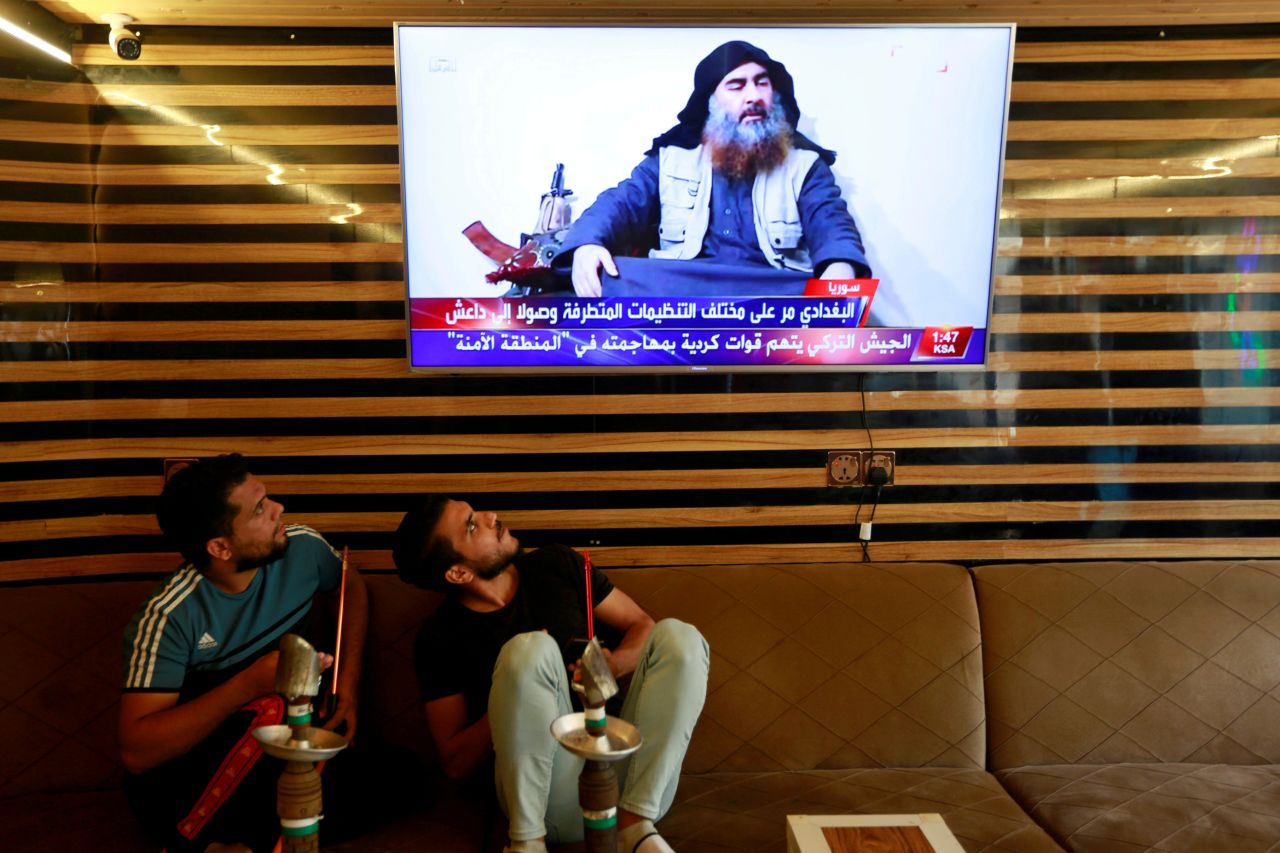 People in Najaf, Iraq, watch a news program reporting about the death of ISIS leader Abu Bakr al-Baghdadi on Sunday, October 27. Al-Baghdadi <a href="https://www.cnn.com/2019/10/27/politics/isis-abu-bakr-al-baghdadi-operation-donald-trump/index.html" target="_blank">was killed in a US military raid</a> in northwest Syria.
