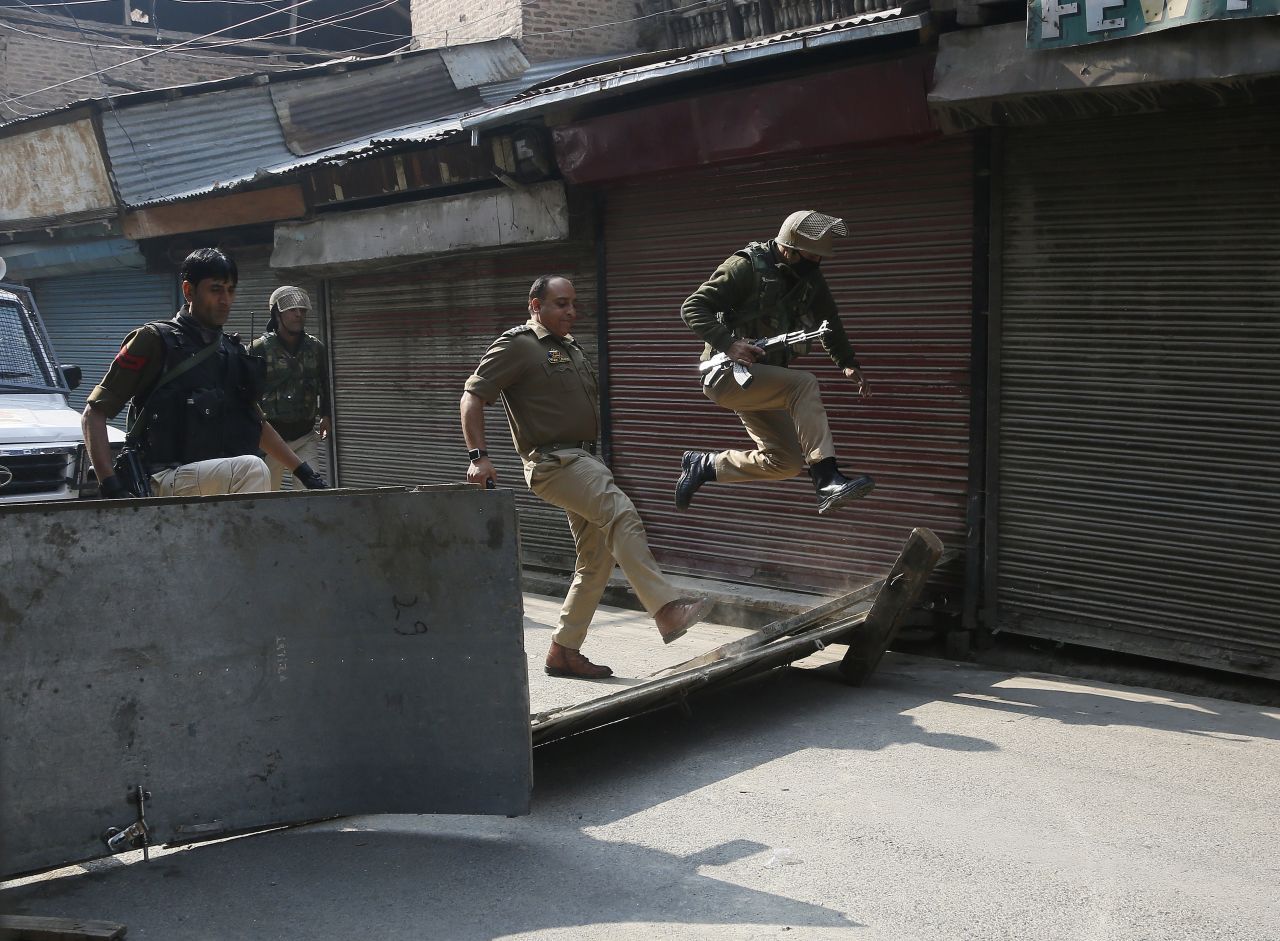 A police officer kicks down a road block put up by protesters in Srinagar, India, on Tuesday, October 29. <a href="https://www.cnn.com/2019/10/31/asia/jammu-kashmir-union-territory-intl-hnk/index.html" target="_blank">India has officially split the former state of Jammu and Kashmir</a> into two union territories, a move that gives the government in New Delhi greater control over the disputed Muslim-majority region.