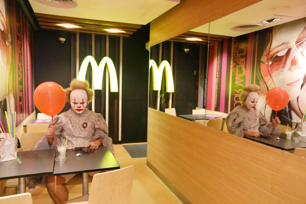 A man dressed up as Pennywise the Clown sits inside a McDonald's in Bangkok, Thailand, on Thursday, October 31.