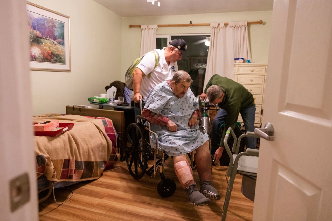 Henry Provencher, 87, receives help from his son Henry, left, and Eric Moessing while evacuating Redwood Retreats, a residential care facility in Santa Rosa, California, on Saturday, October 26. <a href="http://www.cnn.com/2019/10/25/weather/gallery/california-wildfires-2019/index.html" target="_blank">Wildfires</a> have prompted evacuations across the state.