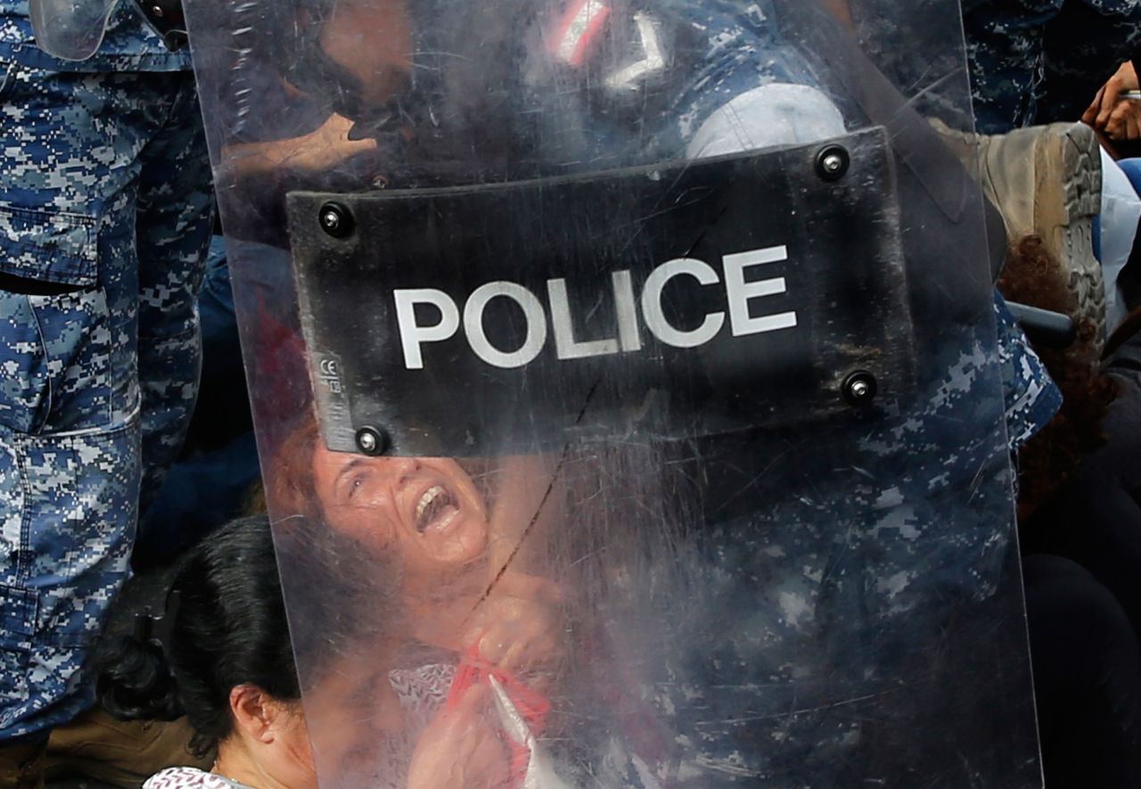 A police officer removes an anti-government protester blocking a main highway in Beirut, Lebanon, on Saturday, October 26. Lebanese Prime Minister Saad Hariri announced a few days that later he was resigning in response to nearly two weeks of <a href="http://www.cnn.com/2019/10/29/world/gallery/lebanon-protests-political-crisis-intl/index.html" target="_blank">nationwide protests.</a> Demonstrations began on October 17 when the government proposed imposing a tax on Whatsapp calls, along with other austerity measures. Hundreds of thousands took to the streets in a bubbling-over of fury at political elites. In recent months, the country has seen rapid economic deterioration, ballooning debt and rising prices.