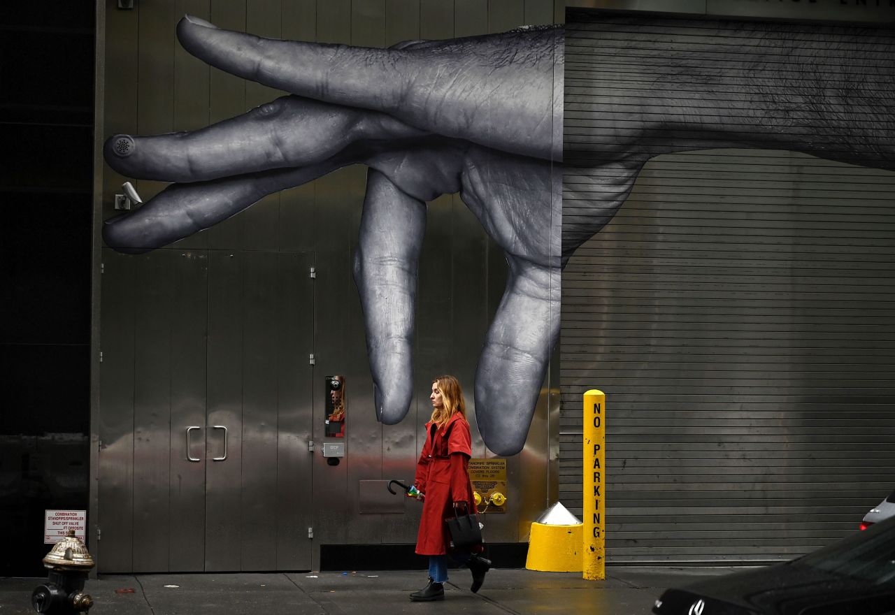 A woman passes a mural in New York on Sunday, October 27.