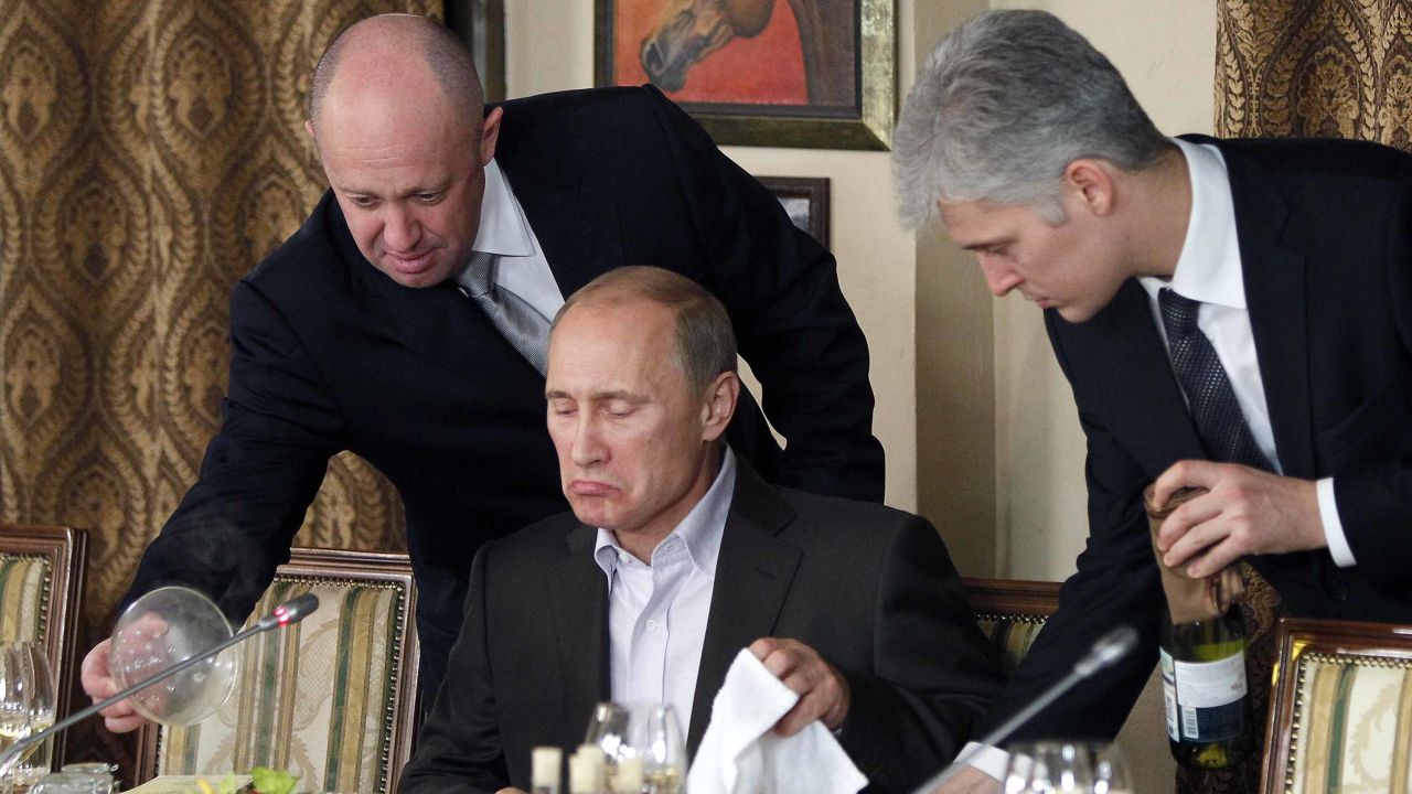 Yevgeny Prigozhin (L) -- AKA 'Putin's chef' -- serves food to Putin in a file photo from 2011. 