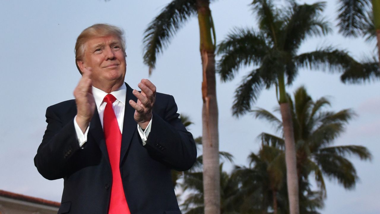 US President Donald Trump watches the Palm Beach Central High School marching band which greeted him as he arrived to watch the Super Bowl at Trump International Golf Club Palm Beach in West Palm Beach, Florida on February 5, 2017. / AFP / MANDEL NGAN        (Photo credit should read MANDEL NGAN/AFP via Getty Images)