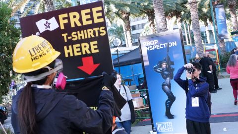Protesters stand outside BlizzCon in Anaheim, California on Friday.