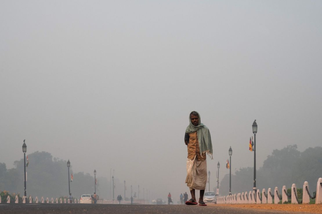 A man walks along a street as a heavy smog hits New Delhi on November 1, 2019. 