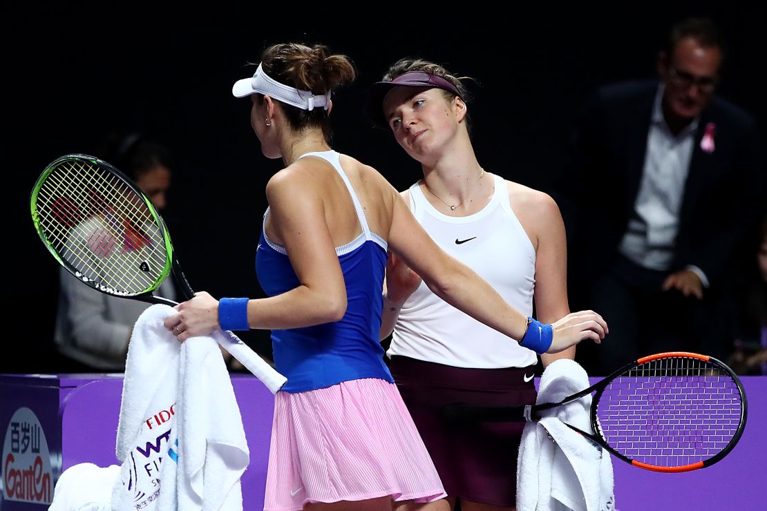 Belinda Bencic (left) of Switzerland is consoled by Ukraine's Elina Svitolina after being forced to retire in the deciding set of their semifinal at the WTA Finals in Shenzhen. 