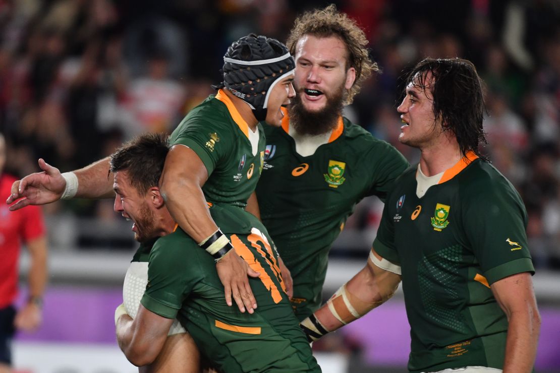 South Africa's wing Cheslin Kolbe (C) is congratulated by teammates after scoring a try against England.