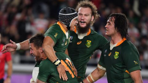 South Africa's wing Cheslin Kolbe (C) is congratulated by teammates after scoring a try against England.