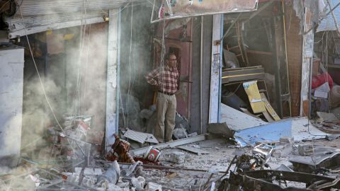 A man inspects the site of the car bomb explosion in Tal Abyad.