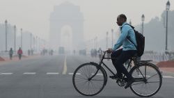 A man rides a cycle past the India Gate on a smoggy morning in New Delhi, India, October 28, 2019 REUTERS/Adnan Abidi