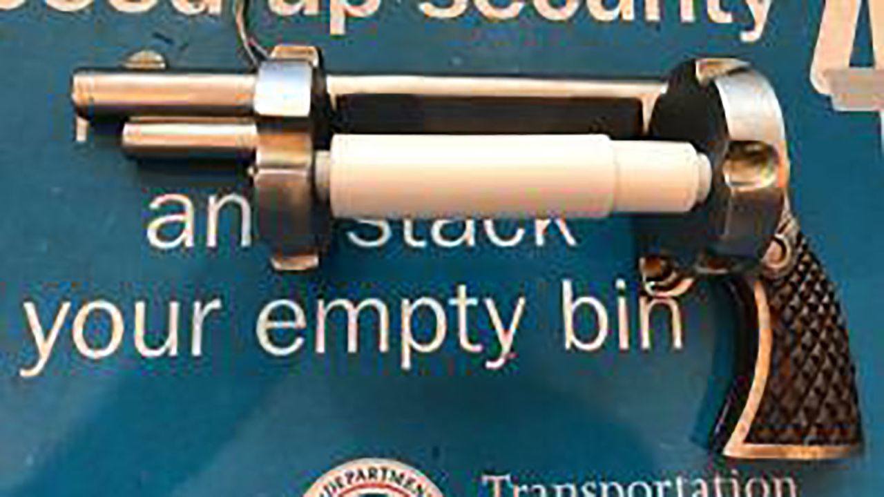 A traveler was stopped when a toilet paper holder shaped like a revolver triggered an alarm at Newark Liberty International Airport.