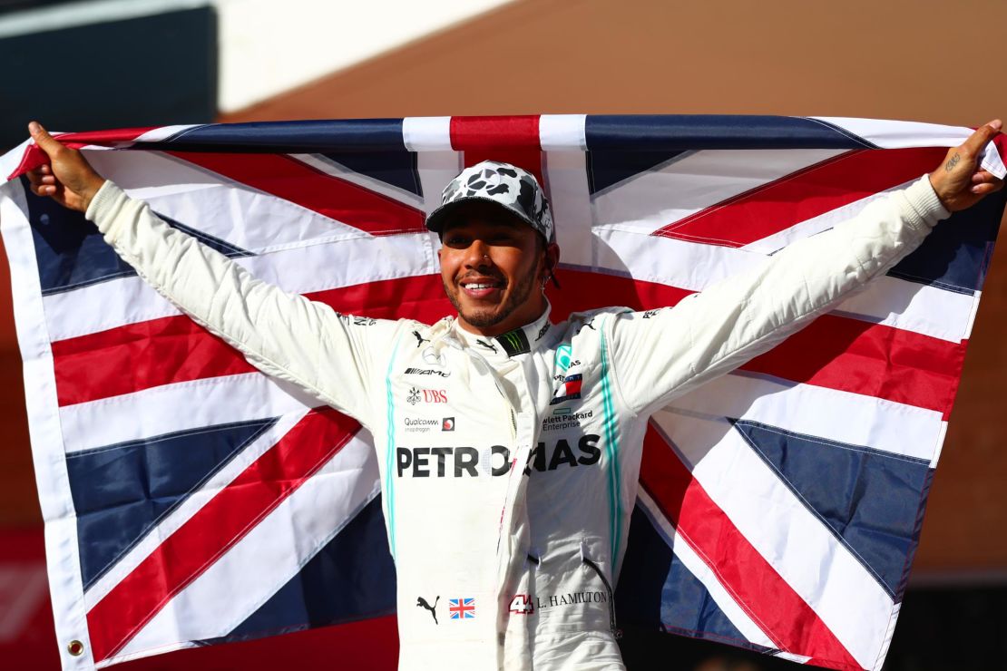 Britain's Lewis Hamilton celebrates in parc ferme after clinching his sixth Formula One world title.