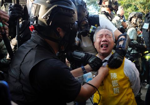 Richard Chan, a candidate for the district council elections, reacts after being pepper-sprayed by police in Hong Kong on November 2. 