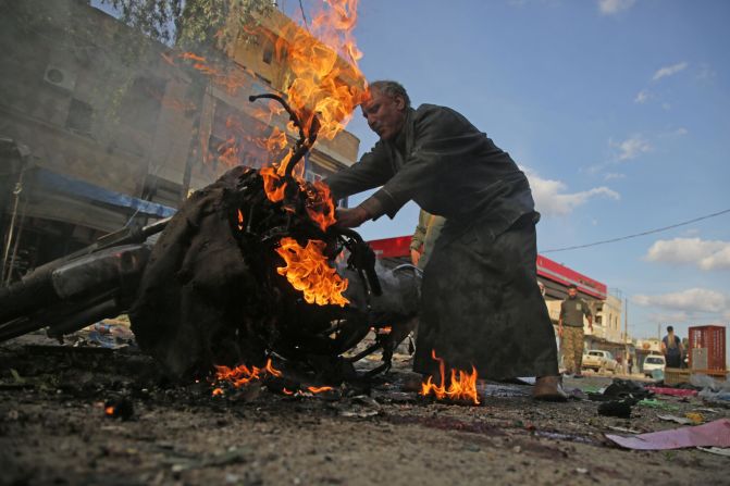 A man stands next to a burning motorcycle at the site of <a href="index.php?page=&url=https%3A%2F%2Fwww.cnn.com%2F2019%2F11%2F02%2Fmiddleeast%2Ftal-abyad-syria-car-bomb-explosion%2Findex.html" target="_blank">a deadly car bomb explosion</a> in Tal Abyad, Syria, on Saturday, November 2. Turkey's defense ministry blamed the Kurdish People's Protection Units and the Kurdistan Workers Party, while a group aligned with the Kurds blamed Turkey.