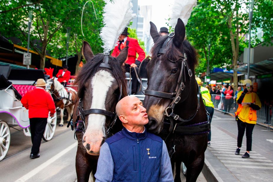Former Melbourne Cup-winning jockey Jimmy Cassidy kisses a parade horse during the 2019 parade in Melbourne, Australia. 
