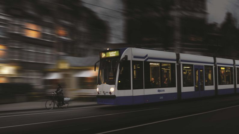 <strong>Multiple forms: </strong>A tram and a bike speed through the streets of Amsterdam in the Netherlands. "People are always at the heart of railways, we want to capture not just cold steel but the stories that are played out, the people who travel and work on the railway," says Coombes.