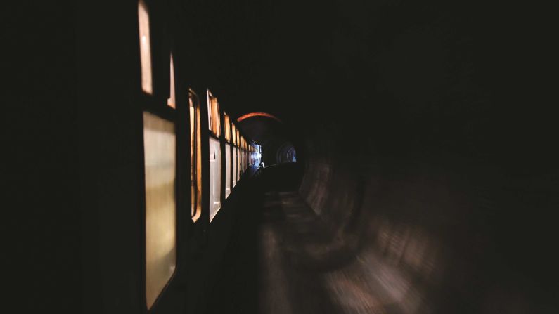 <strong>Tunnel vision</strong>: All these pictures feature in the Coombes' new book, "Railways at Night: from Dusk to Dawn" including this intriguing tunnel shot -- a BR (WR) Modified Hall No. 7903 train dubbed "Foremarke Hall" passes through the Green Tunnel on the Gloucestershire Warwickshire Steam Railway.