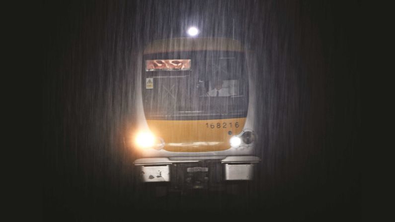 <strong>Trains in the rain: </strong>"We are not 'technical' photographers, who worry about white balance, exposure settings etc, our view is that while you are fiddling with the camera you are not focused on capturing an unfolding scene," says Robin Coombes. Pictured here: a British Rail train Class 168 No. 168216 enters Moor Street Station, in Birmingham in the UK, during a downpour.