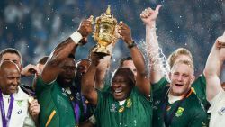 South Africa's President Cyril Ramaphosa (centre R) and South Africa's flanker Siya Kolisi (centre L) lift the Webb Ellis Cup as they celebrate winning the Japan 2019 Rugby World Cup final match between England and South Africa at the International Stadium Yokohama in Yokohama on November 2, 2019. (Photo by Odd ANDERSEN / AFP) / The erroneous mention[s] appearing in the metadata of this photo by Odd ANDERSEN has been modified in AFP systems in the following manner: [South Africa's President Cyril Ramaphosa] instead of [South Africa's hooker Bongi Mbonambi]. Please immediately remove the erroneous mention[s] from all your online services and delete it (them) from your servers. If you have been authorized by AFP to distribute it (them) to third parties, please ensure that the same actions are carried out by them. Failure to promptly comply with these instructions will entail liability on your part for any continued or post notification usage. Therefore we thank you very much for all your attention and prompt action. We are sorry for the inconvenience this notification may cause and remain at your disposal for any further information you may require. (Photo by ODD ANDERSEN/AFP via Getty Images)