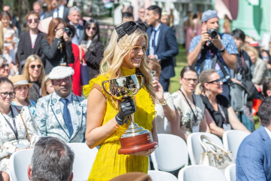 Australian model and personality Tegan Martin carries the Melbourne Cup trophy during the 2019 Melbourne Cup Carnival launch at Flemington Racecourse.