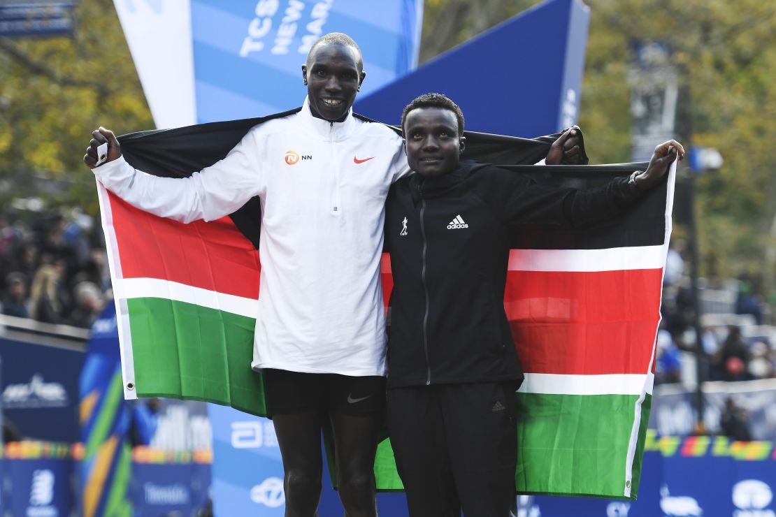 Geoffrey Kamworor and Joyciline Jepkosgei pose with the Kenyan flag after the New York Marathon. 