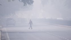 A man crosses a street in smoggy conditions in New Delhi on November 4, 2019. - Millions of people in India's capital started the week on November 4 choking through "eye-burning" smog, with schools closed, cars taken off the road and construction halted. (Photo by Jewel SAMAD / AFP) (Photo by JEWEL SAMAD/AFP via Getty Images)