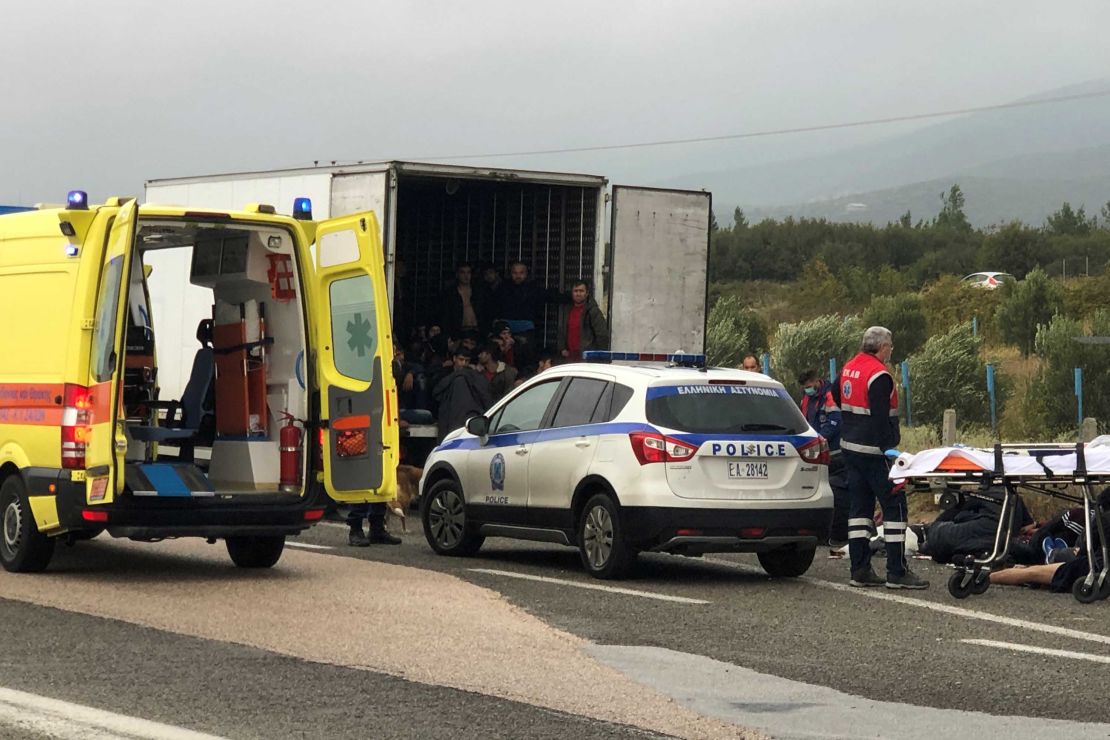 People are seen inside a refrigerated truck found by the police near Xanthi, Greece.
