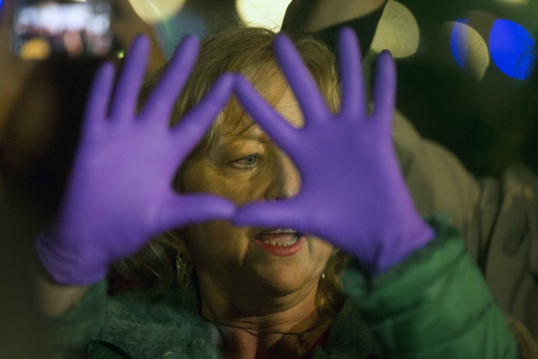 A woman gestures outside the Justice Ministry in Madrid.