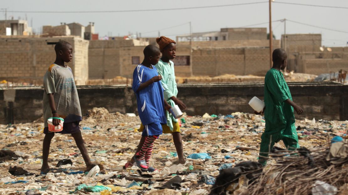 Mamadou, on the far left, with other talibés at the garbage dump which houses his Quranic school, in a part of Saint Louis called Darou.
