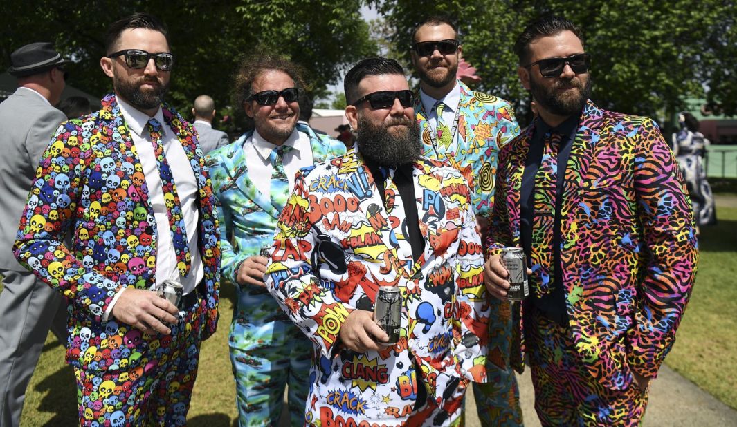 Fans in bright outfits gather to celebrate ahead of the races.